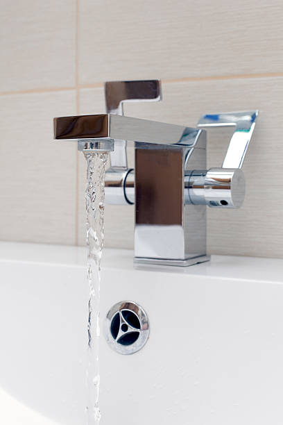 istock Chromium-plate tap on white sink. 496651717