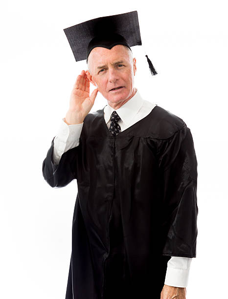 Senior male graduate trying to listen isolated on white backgrou Senior male graduate trying to listen isolated on white background old man cupping his ear to hear something stock pictures, royalty-free photos & images