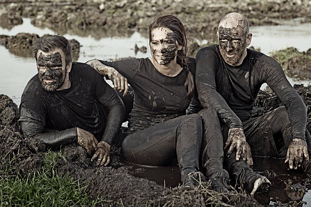 istock friends relaxing after mud obstacle 496652734