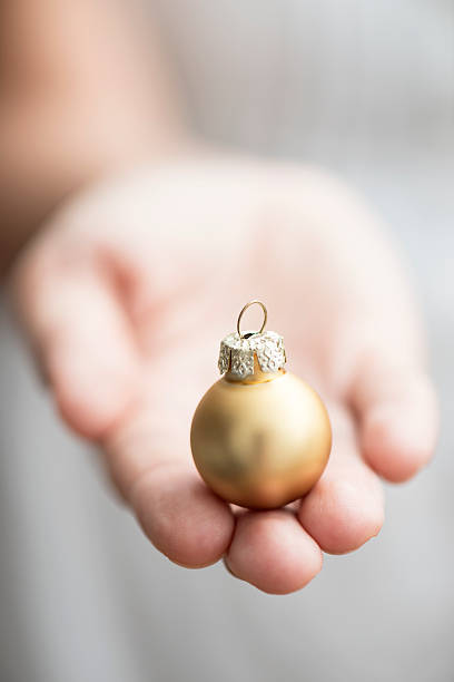 istock Golden Christmas Bauble in Female Hand 496653790