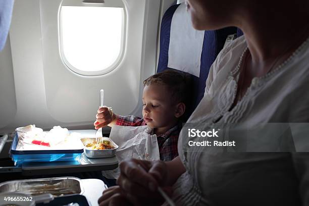 Mother And Son Have Lunch Stock Photo - Download Image Now - Airplane, Eating, People