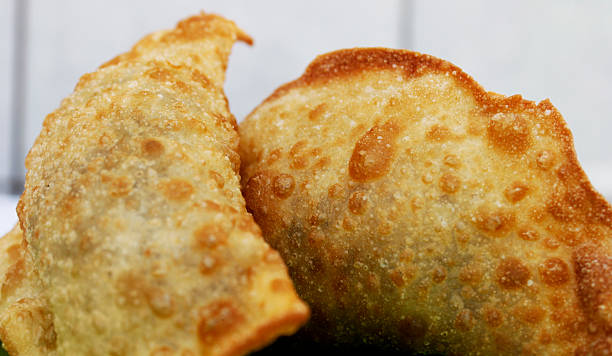 istock Deep fried stuffed pastry. - Pastel food in Brazil 496657776