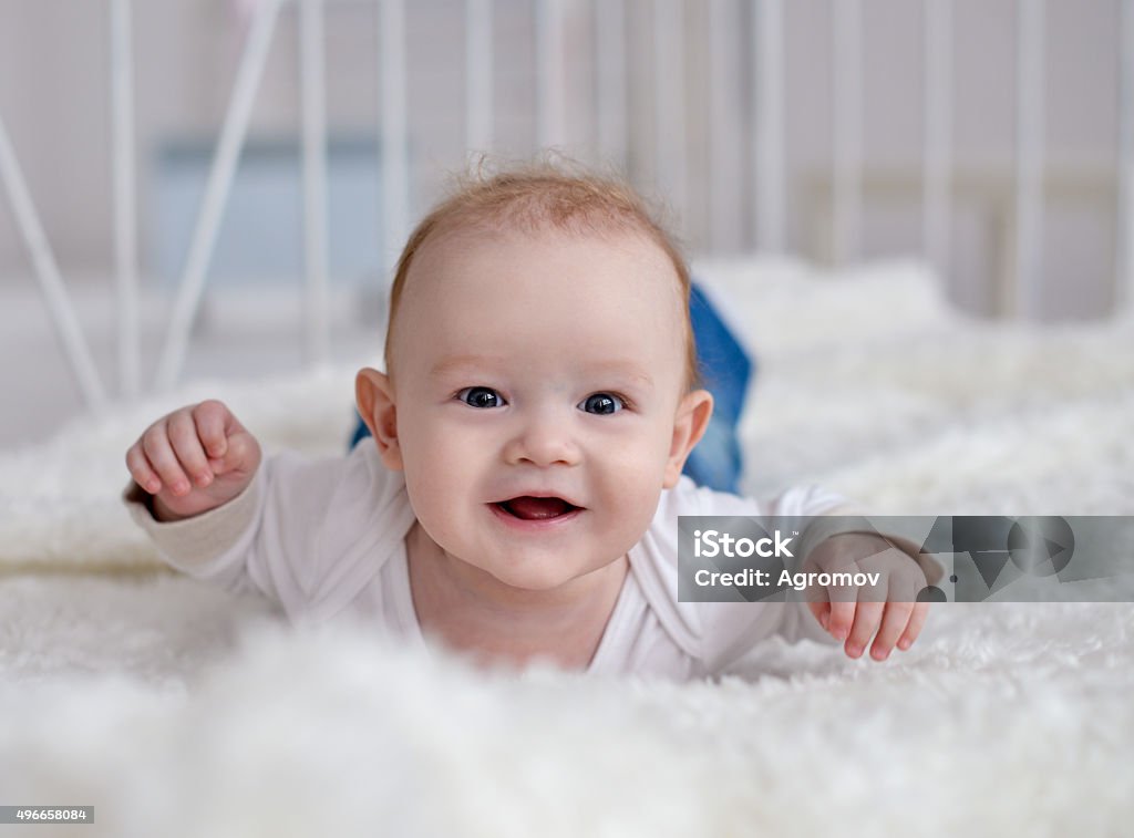 Portrait of a crawling baby on the carpet in room Portrait of a crawling baby on the carpet in room, at home 2015 Stock Photo