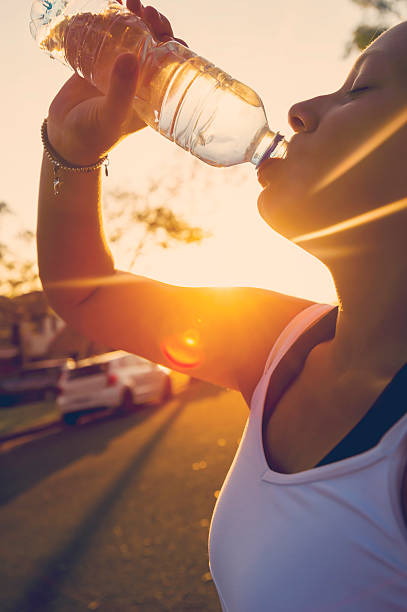 istock Woman athlete drinking water from a bottle 496659658
