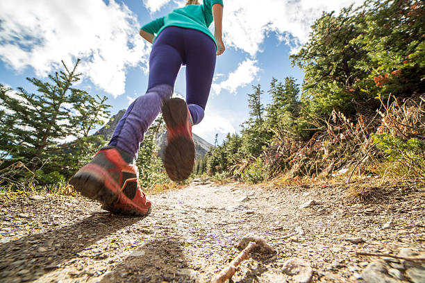istock Low angle of woman running uphill towards sunlight 496660076