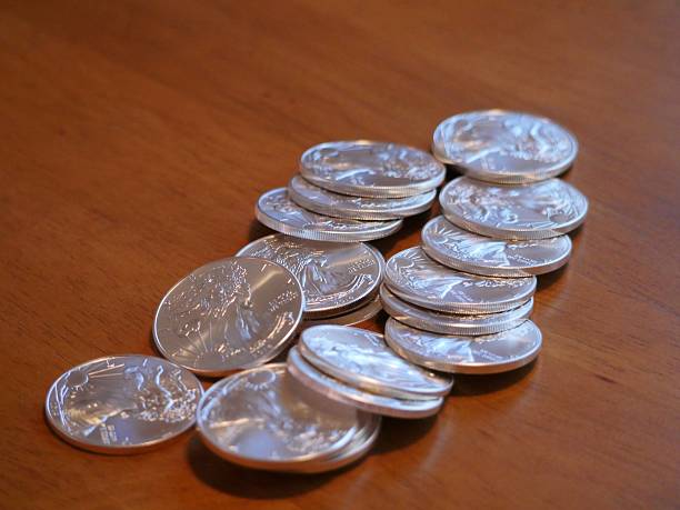 pile of real silver coins stock photo