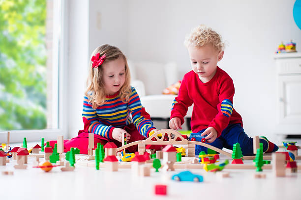 istock Children playing with toy railroad and train 496661016