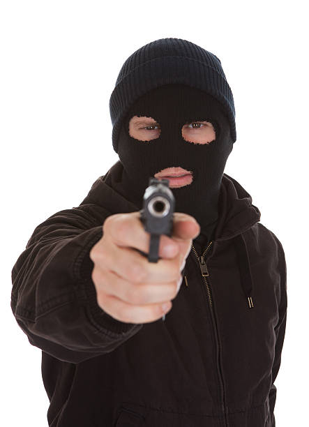 istock Burglar Wearing Mask Holding Gun 496661287