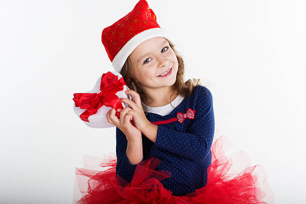 istock Smiling santa girl with red gift box 496661886