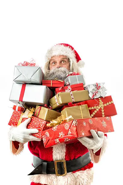 Photo of santa claus holding many gifts isolated on white