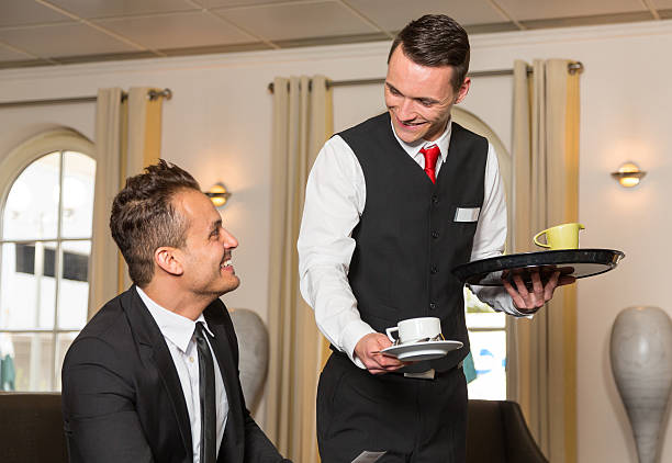 istock Concierge serving guest at hotel a cup of coffee 496662806