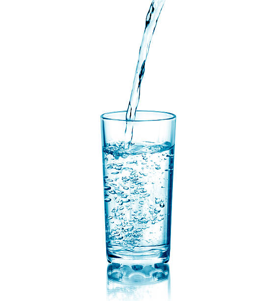 istock Water pouring from bottle into the glass 496663654