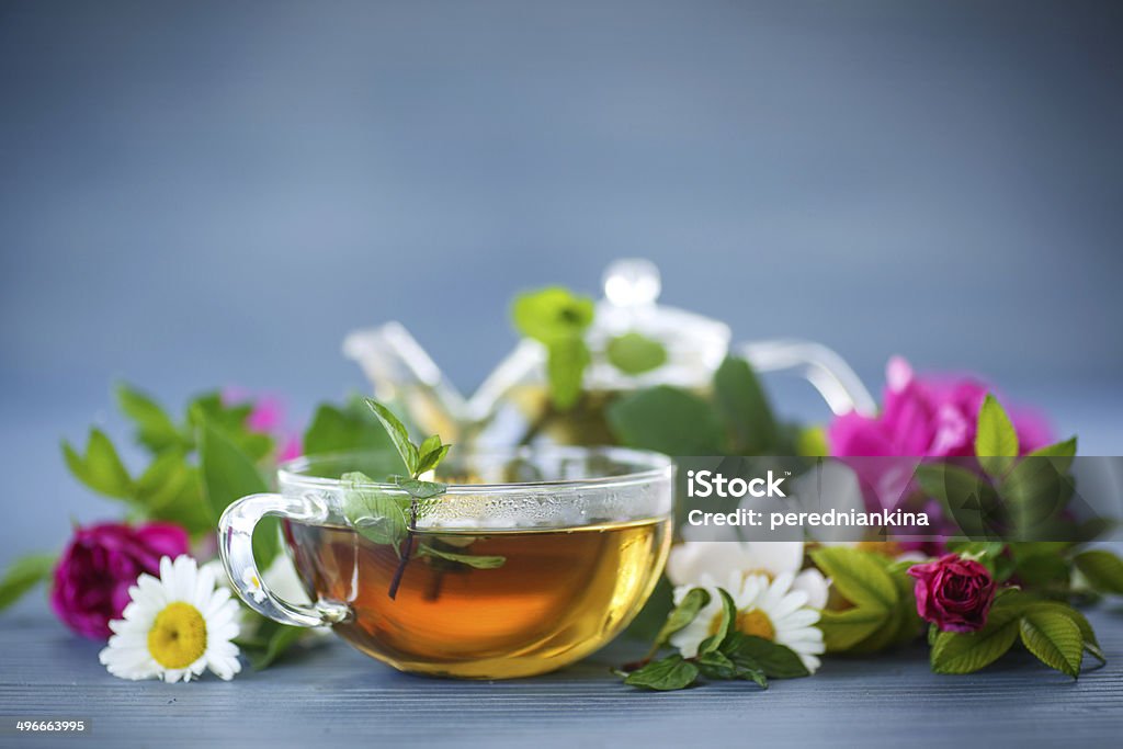 herbal tea flower tea of different flowers in a teapot on the table Rose Hip Stock Photo