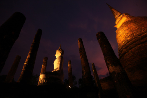 Evening atmosphere with the Buddha in the Wat Sa Si temple in the temple complex of Old Sukhothai in the province of Sukhothai in the north of Thailand in South East Asia.