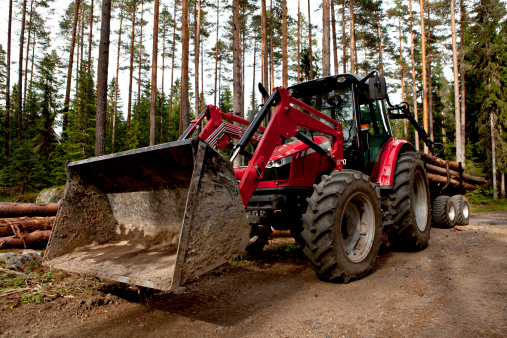 red forestry tractor with logs