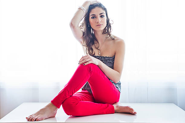 istock Teenage girl posing on table 496665116