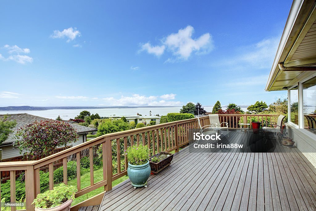 Walkout deck water view Wooden walkout deck with patio table and water view. Architecture Stock Photo