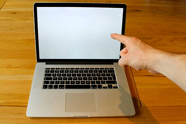 istock Pointing at blank laptop with right hand 496666983