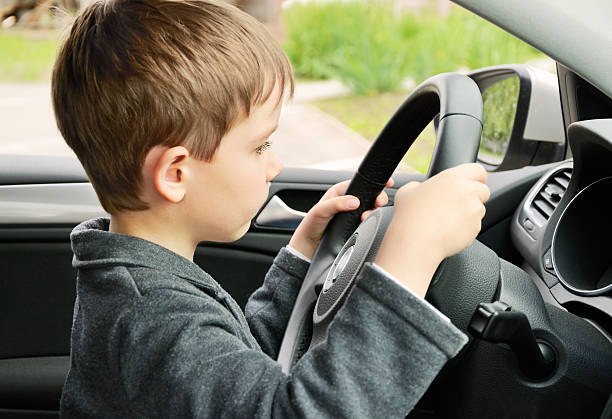 istock boy driving a car and looking at the way 496667593
