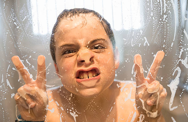 istock young boy playing in the shower 496669135