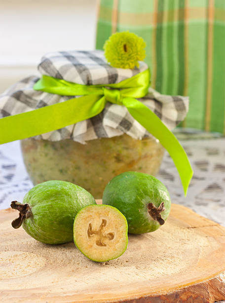 Feijoa on a background of cans of fruit puree stock photo