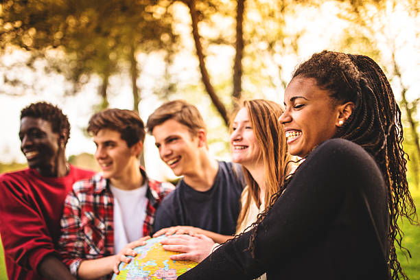 istock teenagers college student smiling with globe 496679327