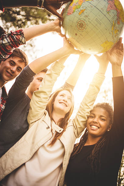 istock teenagers college student smiling with globe 496679359