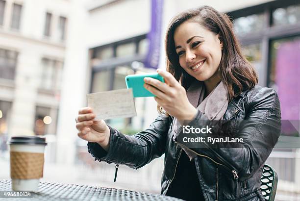 New York Woman Depositing Check Remotely Stock Photo - Download Image Now - Portable Information Device, Bank Deposit Slip, Check - Financial Item