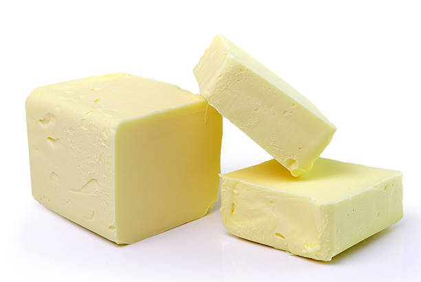 istock Stick of butter, cut, isolated on white. 496680211