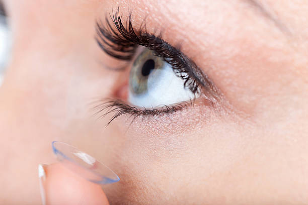 istock Woman eye with contact lens applying 496680551