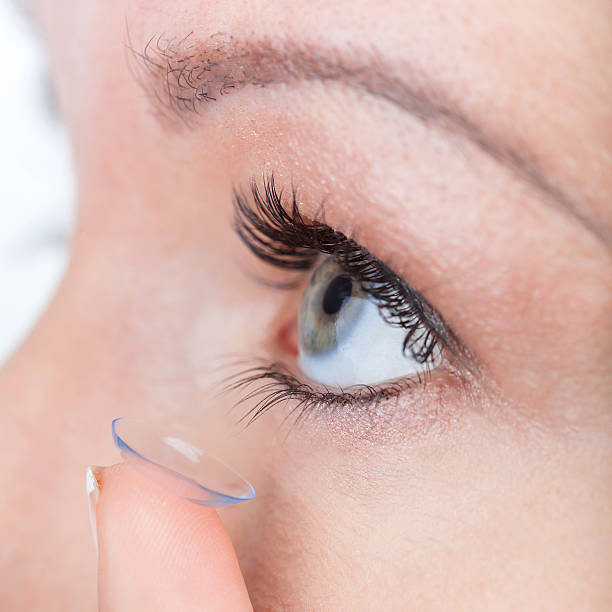 istock Woman eye with contact lens applying 496680557