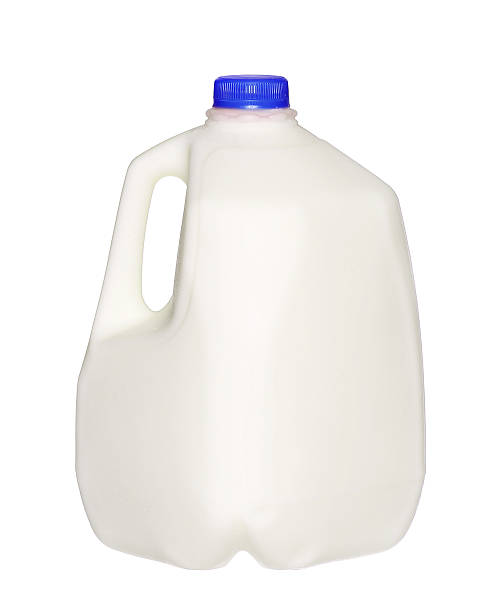 gallon Milk Bottle with blue Cap Isolated on White gallon Milk Bottle with blue Cap Isolated on White Background. gallon stock pictures, royalty-free photos & images