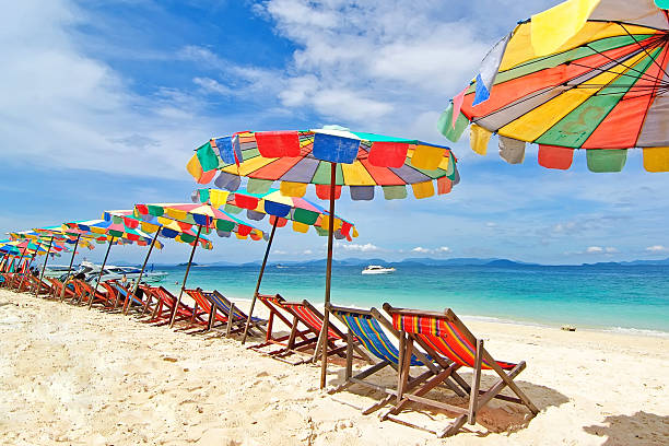 istock Beach chairs and colorful umbrella on the beach 496682011