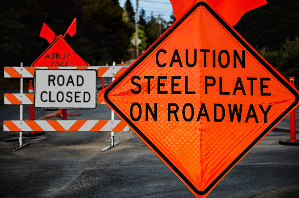 Caution Steel Plate On Roadway The Caution Steel Plate On Roadway, Road Closed, and Abrupt Edge signs direct traffic away from the construction zone hazards. road chevron warning signs stock pictures, royalty-free photos & images