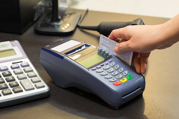 istock Hand Swiping Credit Card In Store 496683528