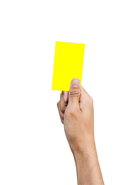 istock Hand of referee with yellow card isolated on white background 496684533