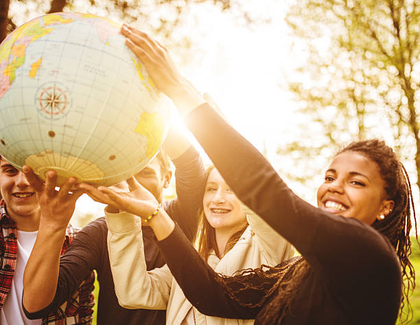istock teenagers college student smiling with globe 496684729