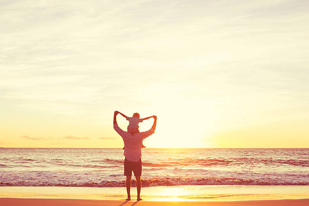istock Father and Son Playing on the Beach at Sunset 496687216