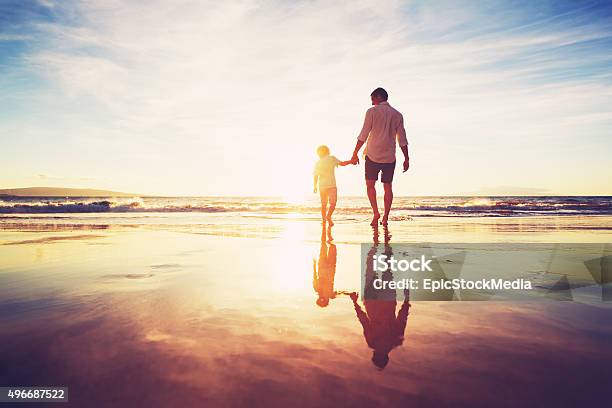 Father And Son Walking Together Holding Hands Stock Photo - Download Image Now - 2015, Adult, Carefree