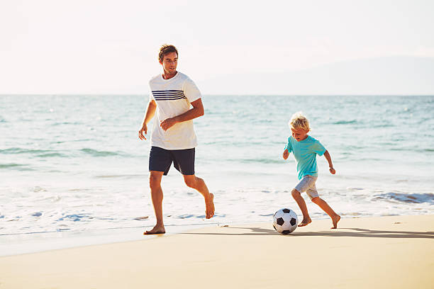 istock Father and Son Playing Soccer 496688054