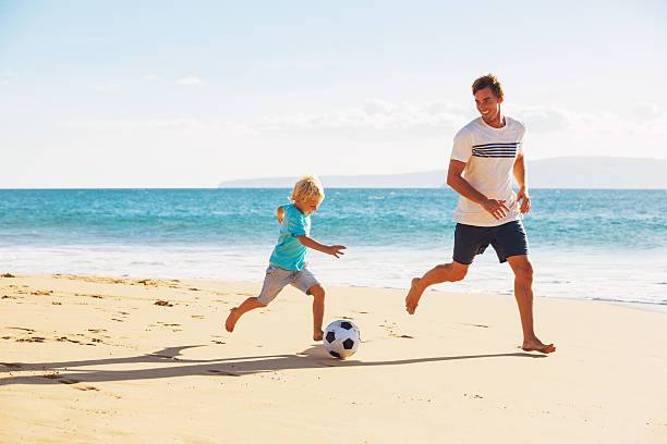 istock Father and Son Playing Soccer 496688100