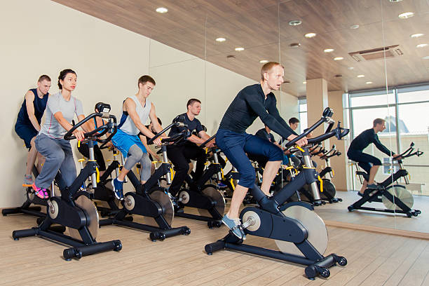 istock Group of gym people on machines, cycling In Class 496688452