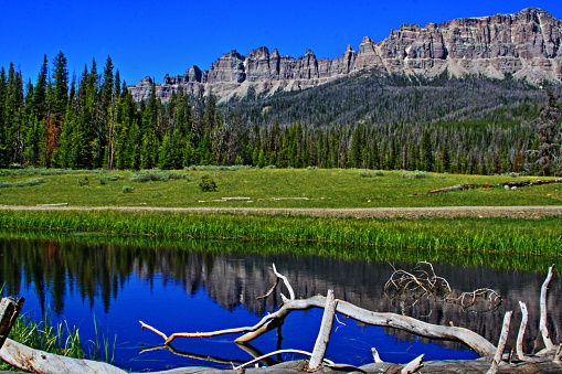 Wind River Lake which is a high mountain lake on Togwotee Pass with Breccia Cliffs and Breccia and Sublette Peaks in the Absaroka Mountains in the summer in Wyoming USA.  This is the mountain pass between Dubois Wyoming and the Grand Tetons National Park / Jackson Hole (valley) where the Absaroka and Wind River mountain ranges of the Rockies meet.