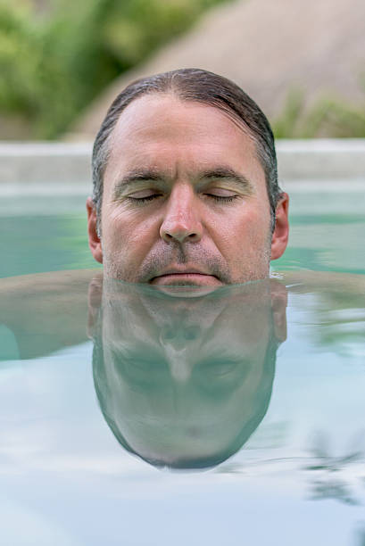 istock Man relaxing at the swimming pool 496699250