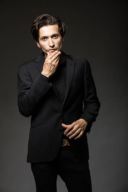 attractive man in black suit stock photo