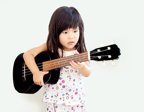 istock asian girl play ukulele 496701298
