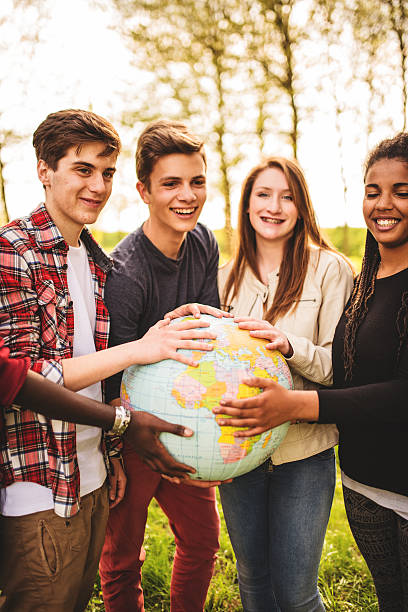 istock teenagers college student smiling with globe 496701449