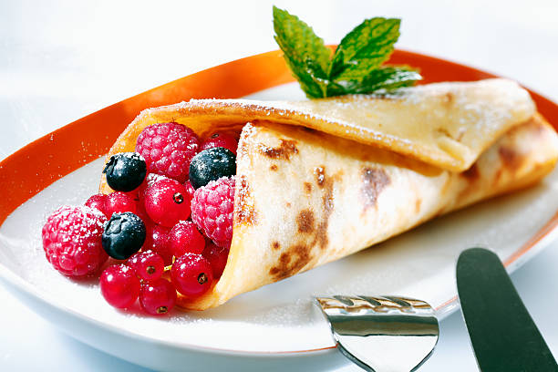 istock Golden pancake filled with berries 496701674