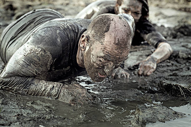 istock group of friends crawling in mud 496702440