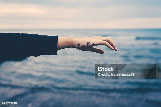 Girl With Birds Tattooed On The Hand Freedom Concept Stock Photo - Download Image Now